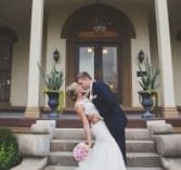 Bride and Groom kissing in front of The Pepin Mansion
