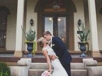 Bride and Groom kissing in front of The Pepin Mansion
